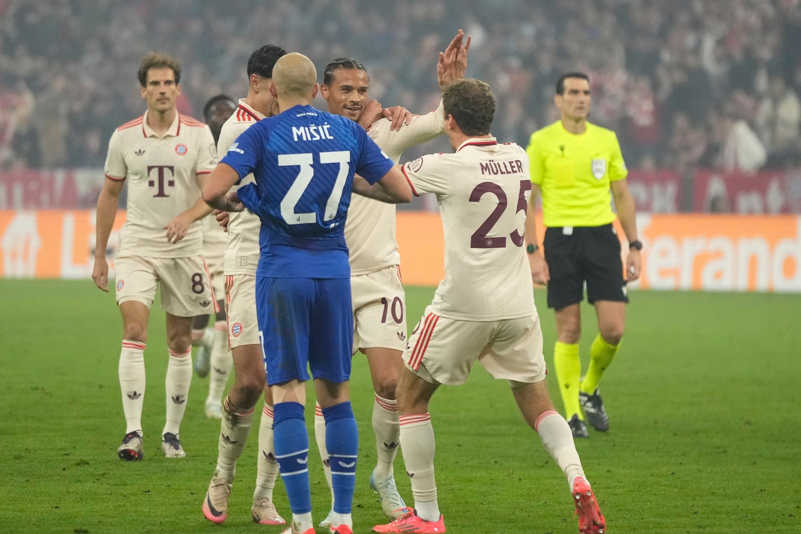 Bayern's Leroy Sane, second right celebrates with teammates after scoring his sides 8th goal, during the Champions League opening phase soccer match between Bayern Munich and GNK Dinamo at the Allianz Arena in Munich, Germany Tuesday, Sept. 17, 2024. (AP Photo/Matthias Schrader)