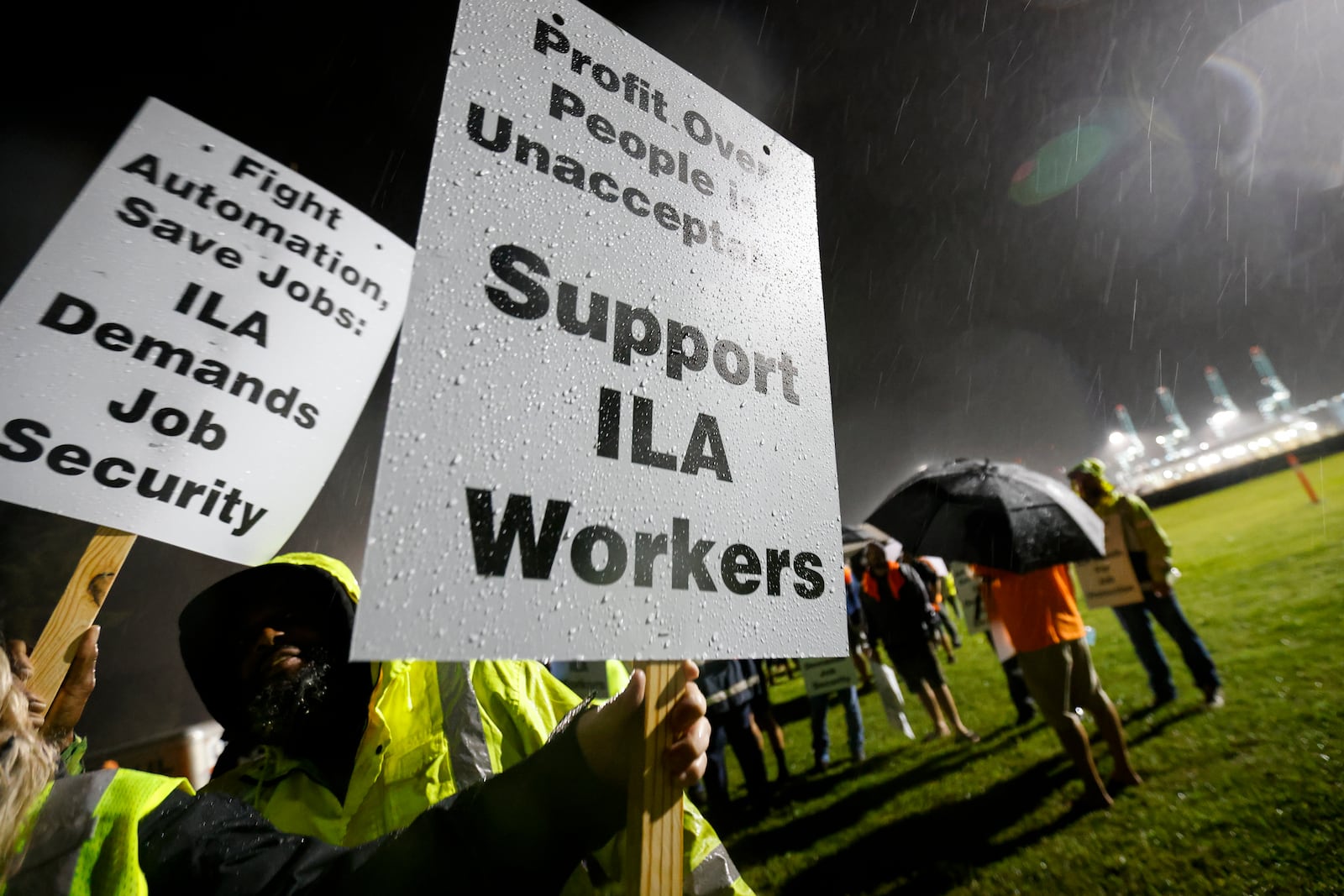 Hundreds of longshoremen strike together outside of the Virginia International Gateway in Portsmouth, Va., Tuesday, Oct. 1, 2024. (Billy Schuerman/The Virginian-Pilot via AP)