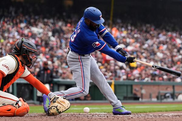 Texas Rangers' Adolis García, right, strikes out next to San Francisco Giants catcher Patrick Bailey during the sixth inning of a baseball game Sunday, April 27, 2025, in San Francisco. (AP Photo/Godofredo A. Vásquez)