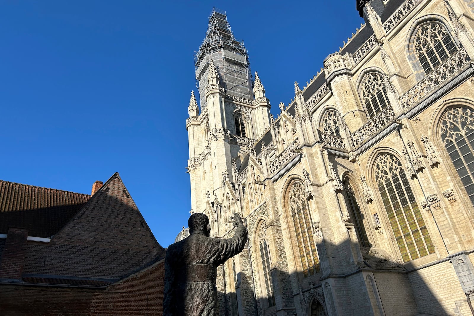 An exterior view of St. Martin's Basilica with the statue of 20th century Cardinal Jozef Cardijn, in Halle, Belgium, Sept. 15, 2024. (AP Photo/Raf Casert)