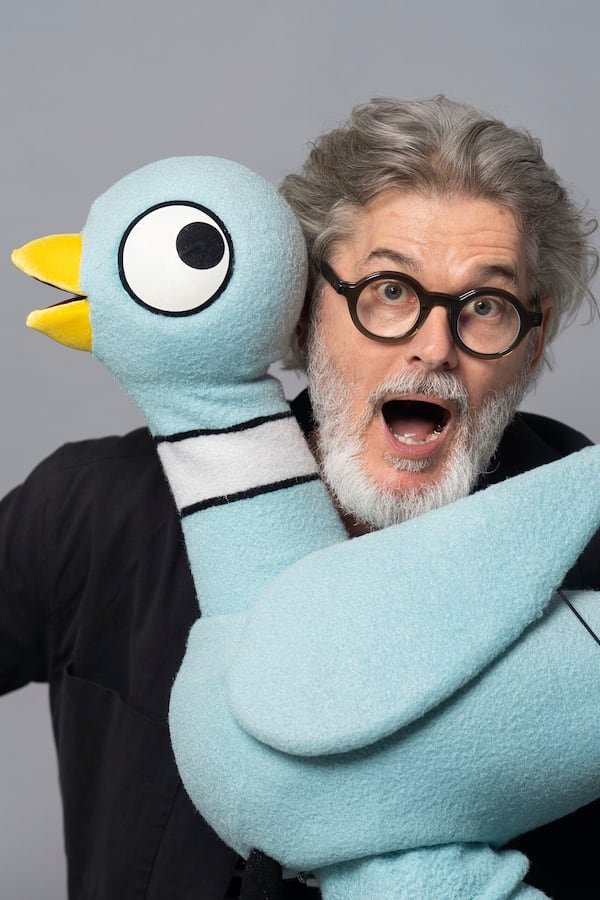 Author Mo Willems poses with The Pigeon, a character in his children's books, on April 22, 2025, in New York. (AP Photo/Gary Gerard Hamilton)
