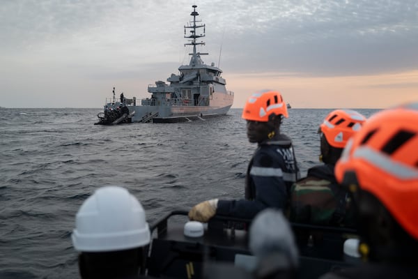 Senegalese sailors in their zodiac approach a fishermen's pirogue to check during a mission to search for illegal migrant boats near the coast of Dakar, Senegal, Saturday, Nov.16, 2024. (AP Photo/Sylvain Cherkaoui)