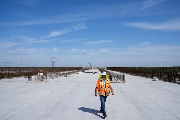 Eduardo Reyes, senior transportation engineer with the California High-Speed Rail Authority, walks through the Hanford Viaduct construction site, Tuesday, April 15, 2025, in Kings County, Calif. (AP Photo/Godofredo A. Vásquez)