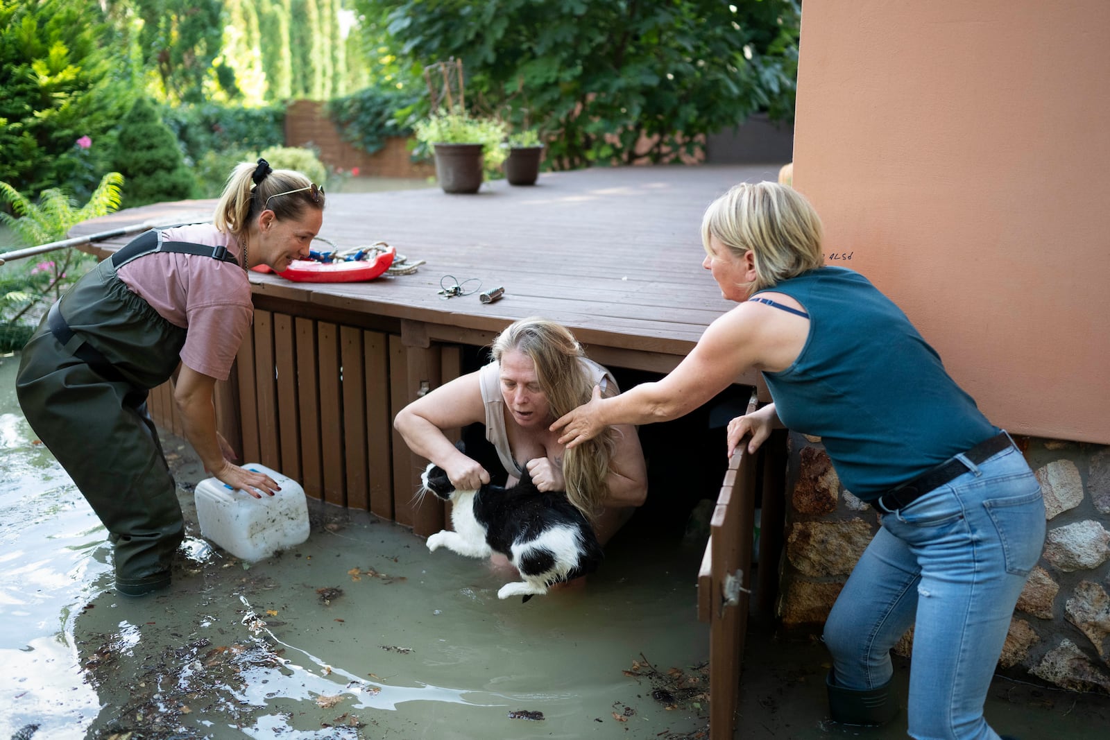 Women save a cat from floods in Szentendre, near Budapest, Hungary, as the Danube river flooded its banks on Thursday, Sept. 19, 2024. (AP Photo/Denes Erdos)