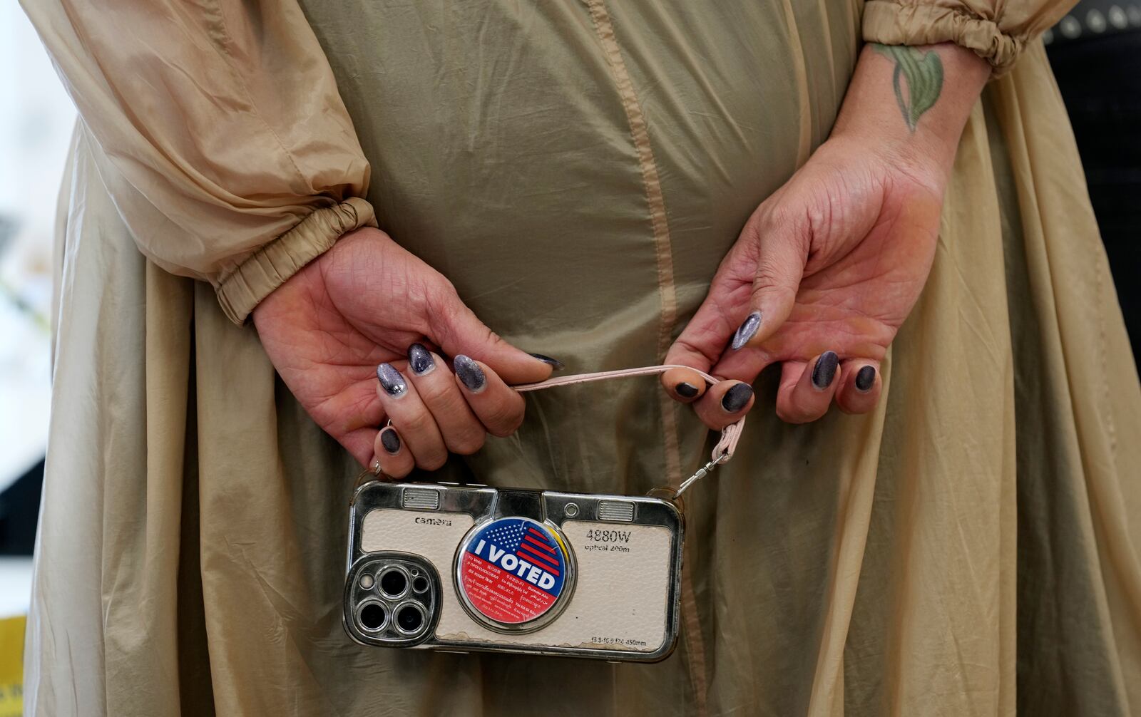 Marsha Molinari of West Hollywood, Calif., holds a cell phone at a polling place at the Connie Norman Transgender Empowerment Center on Election Day, Tuesday, Nov. 5, 2024, in West Hollywood, Calif. (AP Photo/Chris Pizzello)