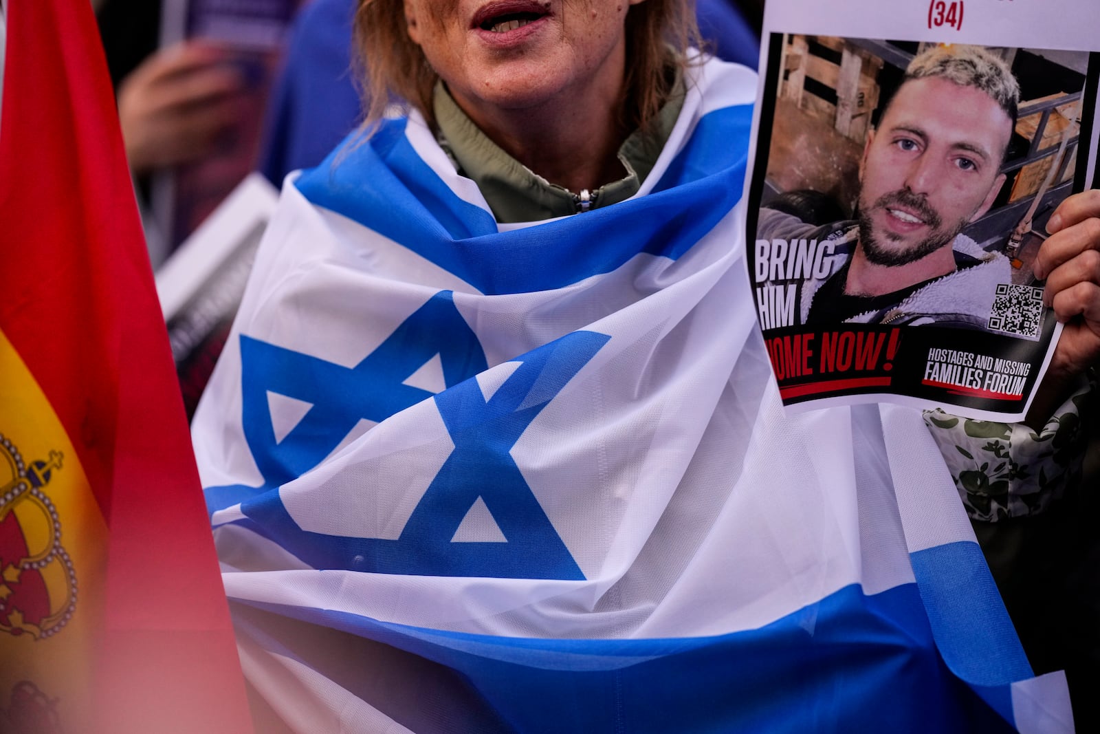 An activist holds a picture of the hostage during a commemoration to mark the one-year anniversary of the Israel Hamas war in Madrid, Spain, Monday, Oct. 7, 2024. (AP Photo/Manu Fernandez)