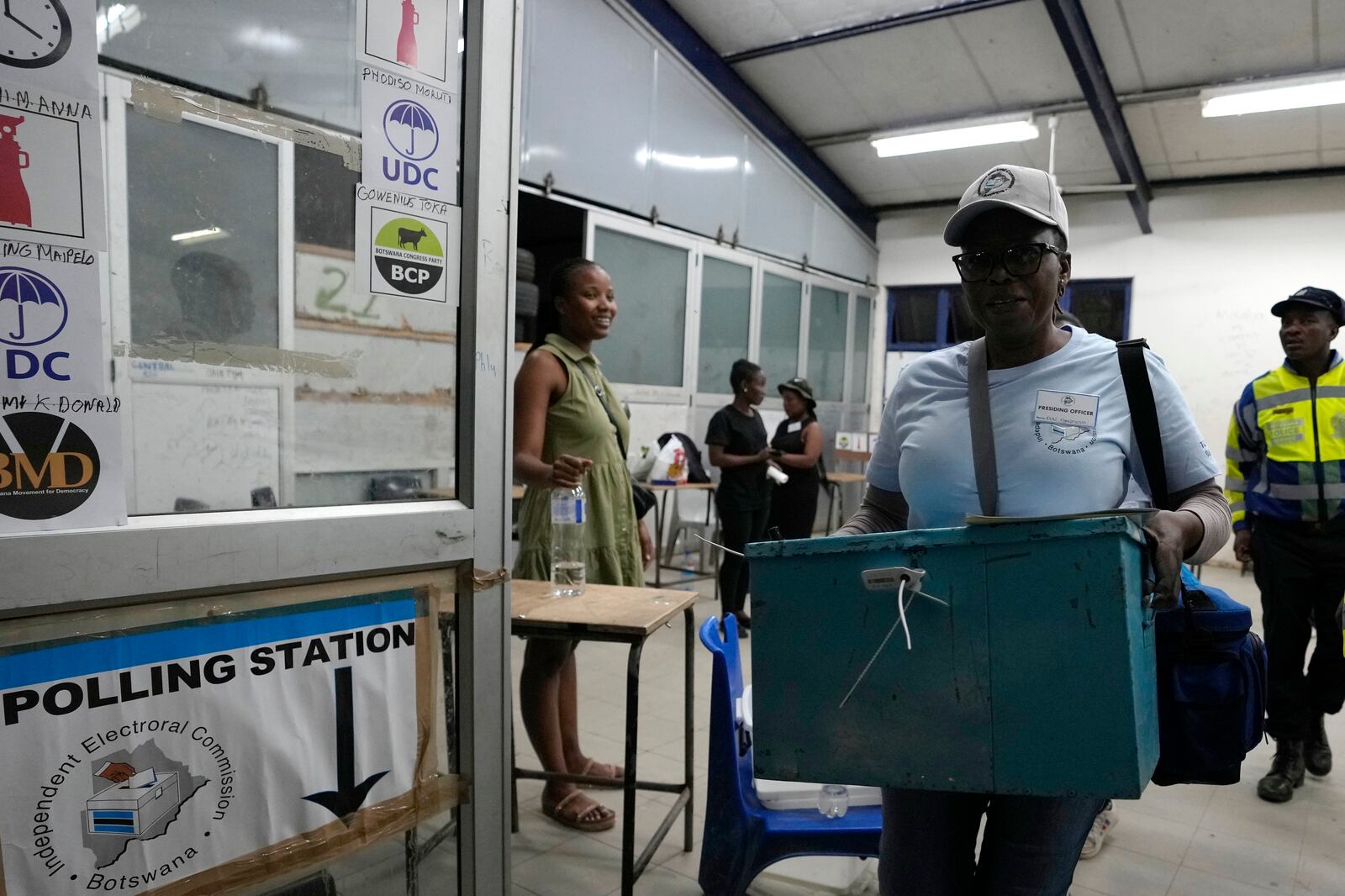 An electoral worker carries a ballot box after the closing of a voting station during the elections at Old Naledi township, on the outskirts of Gaborone, Botswana, Wednesday, Oct. 30, 2024. (AP Photo/Themba Hadebe)