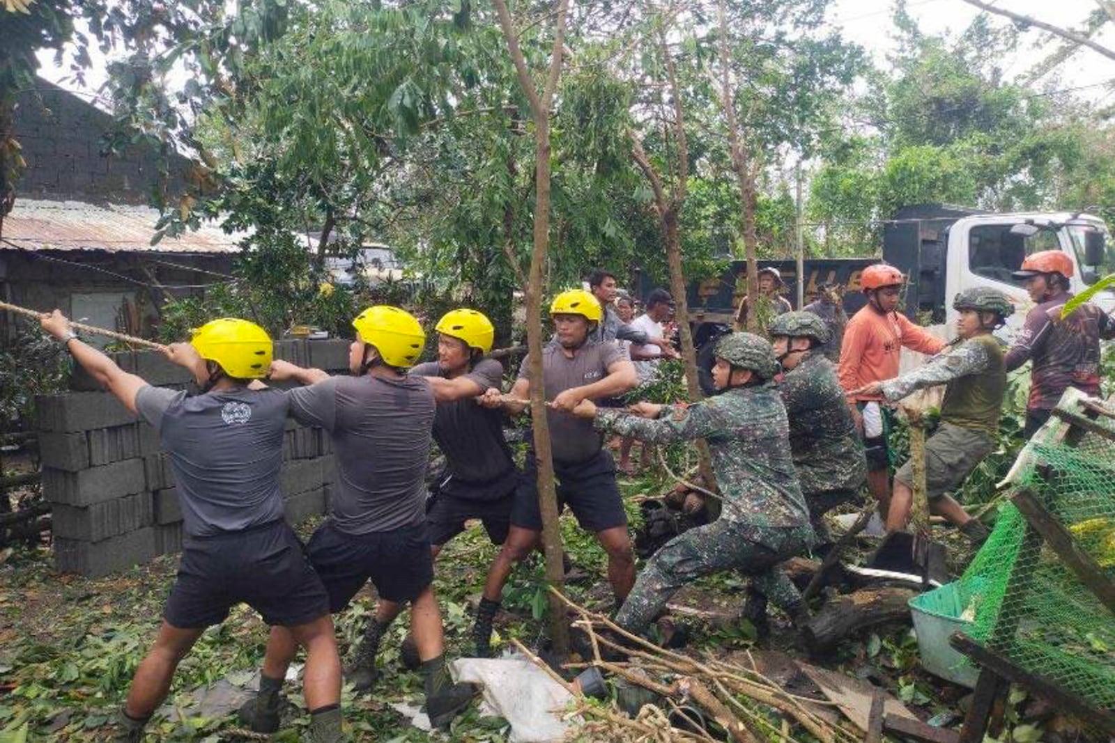 In this photo provided by the Provincial Disaster Risk Reduction and Management Office Cagayan, soldiers and rescuers help clear an area from debris and toppled trees caused by Typhoon Yinxing in Sanchez Mira, Cagayan province, northern Philippines Friday Nov. 8, 2024. (Provincial Disaster Risk Reduction and Management Office, Cagayan via AP)