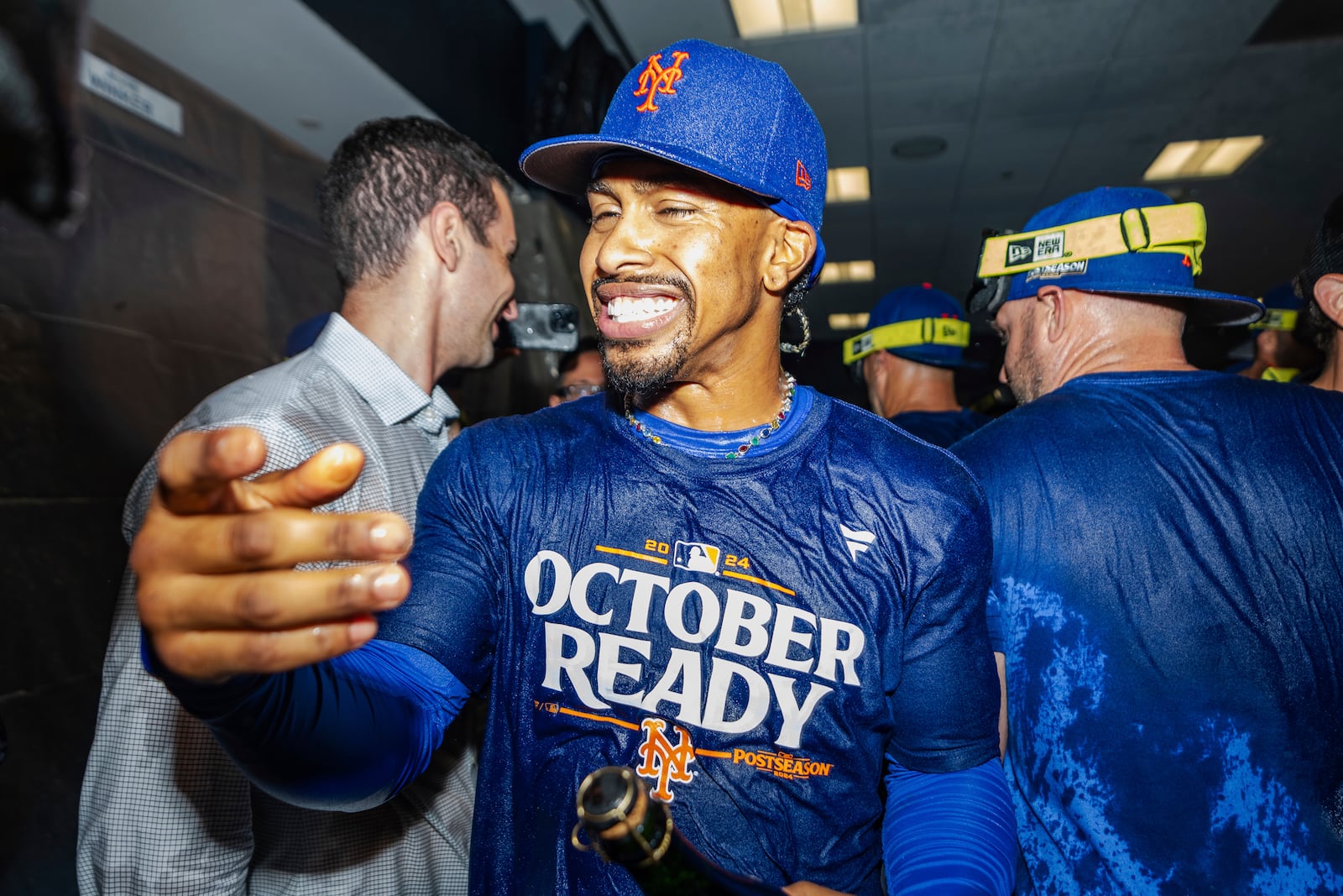 New York Mets shortstop Francisco Lindor celebrates in the locker room after clinching a playoff berth with a victory in the first game of a doubleheader against the Atlanta Braves, Monday, Sept. 30, 2024, in Atlanta. (AP Photo/Jason Allen)