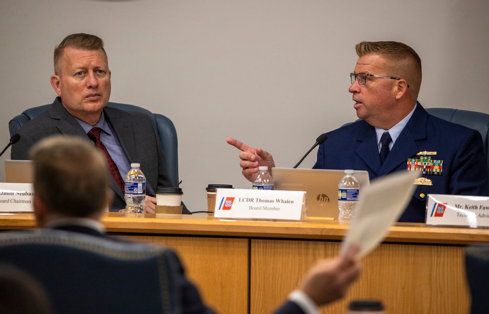 Board Chairman Jason Neubauer, left, and board member Thomas Whalen, board member, of the investigative board for the Titan marine board formal hearing, speak with former OceanGate's Director of Marine Operations David Lochridge, foreground left, Tuesday, Sept. 17, 2024, in North Charleston, S.C. (Andrew J. Whitaker/The Post and Courier/The Post And Courier via AP, Pool)