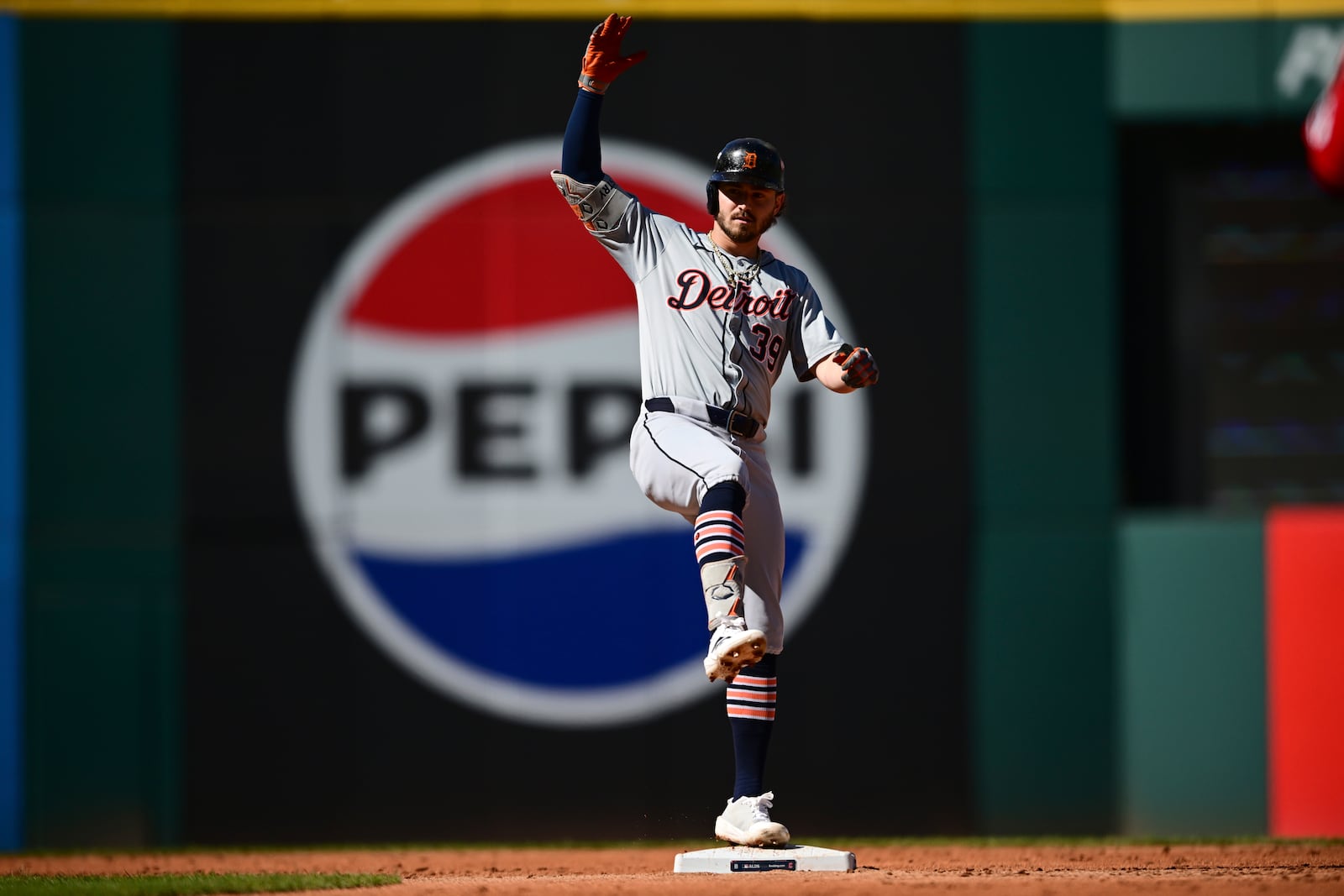 Detroit Tigers' Zach McKinstry celebrates a hitting a double at second base during the second inning of Game 1 of baseball's AL Division Series against the Cleveland Guardians, Saturday, Oct. 5, 2024, in Cleveland. (AP Photo/David Dermer)