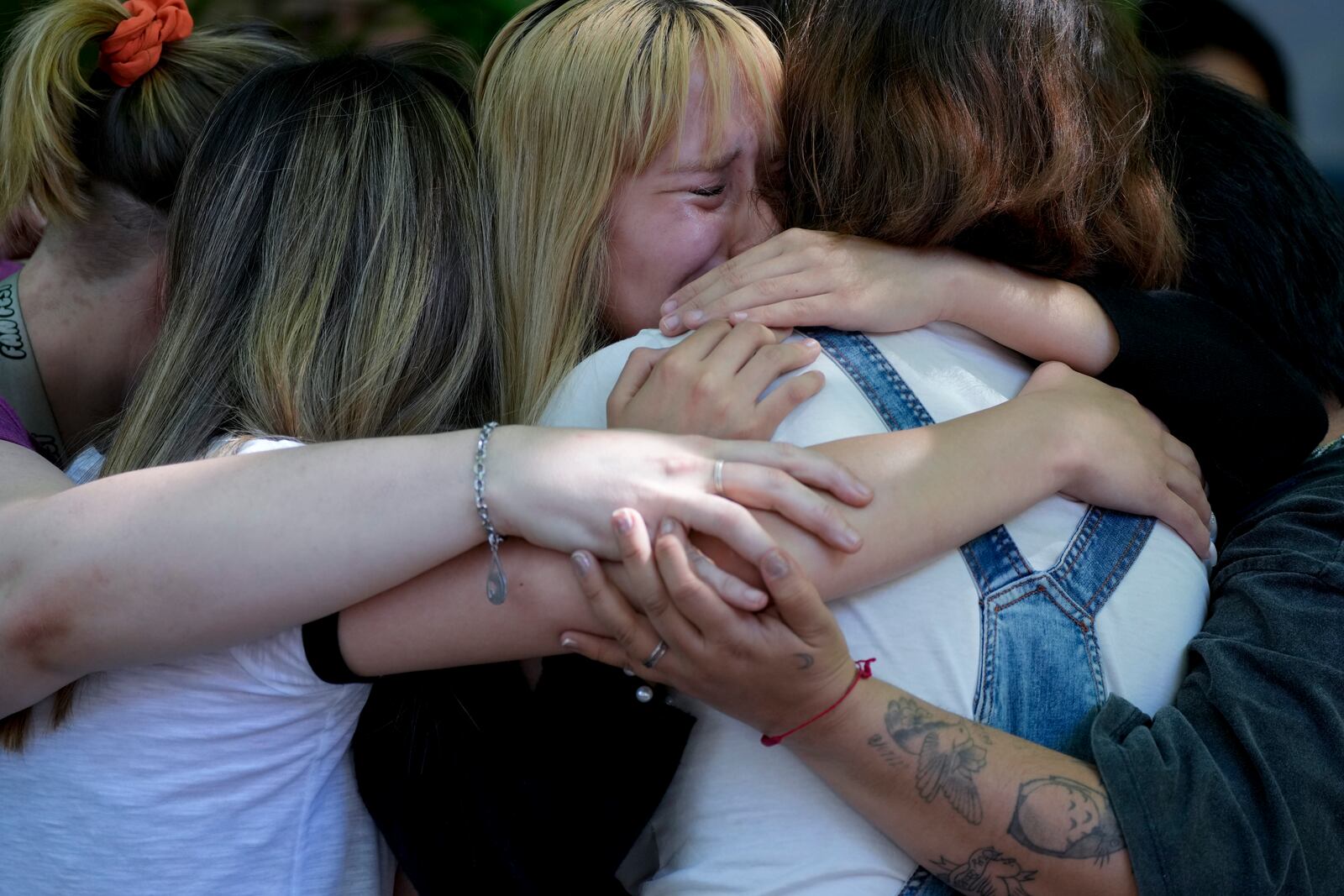 Fans of former One Direction singer Liam Payne grieve outside Casa Sur Hotel where the British pop singer fell to his death from a hotel balcony, in Buenos Aires, Argentina, Friday, Oct. 18, 2024. (AP Photo/Natacha Pisarenko)