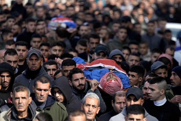 Mourners attend the funeral of Ahmad Zaid, 20, and Muhammad Hamarsheh, 13, who were killed during an Israeli military raid in the village of Yabad near the West Bank city of Jenin, Monday, Nov. 25, 2024. (AP Photo/Majdi Mohammed)