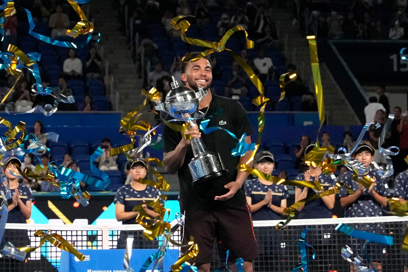 Arthur Fils of France celebrates with the trophy after defeating his compatriot Ugo Humbert in their men's singles final match at the Japan Open tennis tournament on Tuesday, Oct. 1, 2024, at Ariake Coliseum, in Tokyo, Japan. (AP Photo/Eugene Hoshiko)