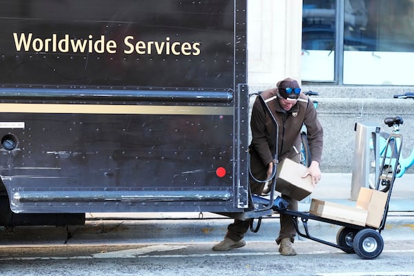 A UPS driver loads packages for delivery in Chicago, Wednesday, Nov. 20, 2024. (AP Photo/Nam Y. Huh)