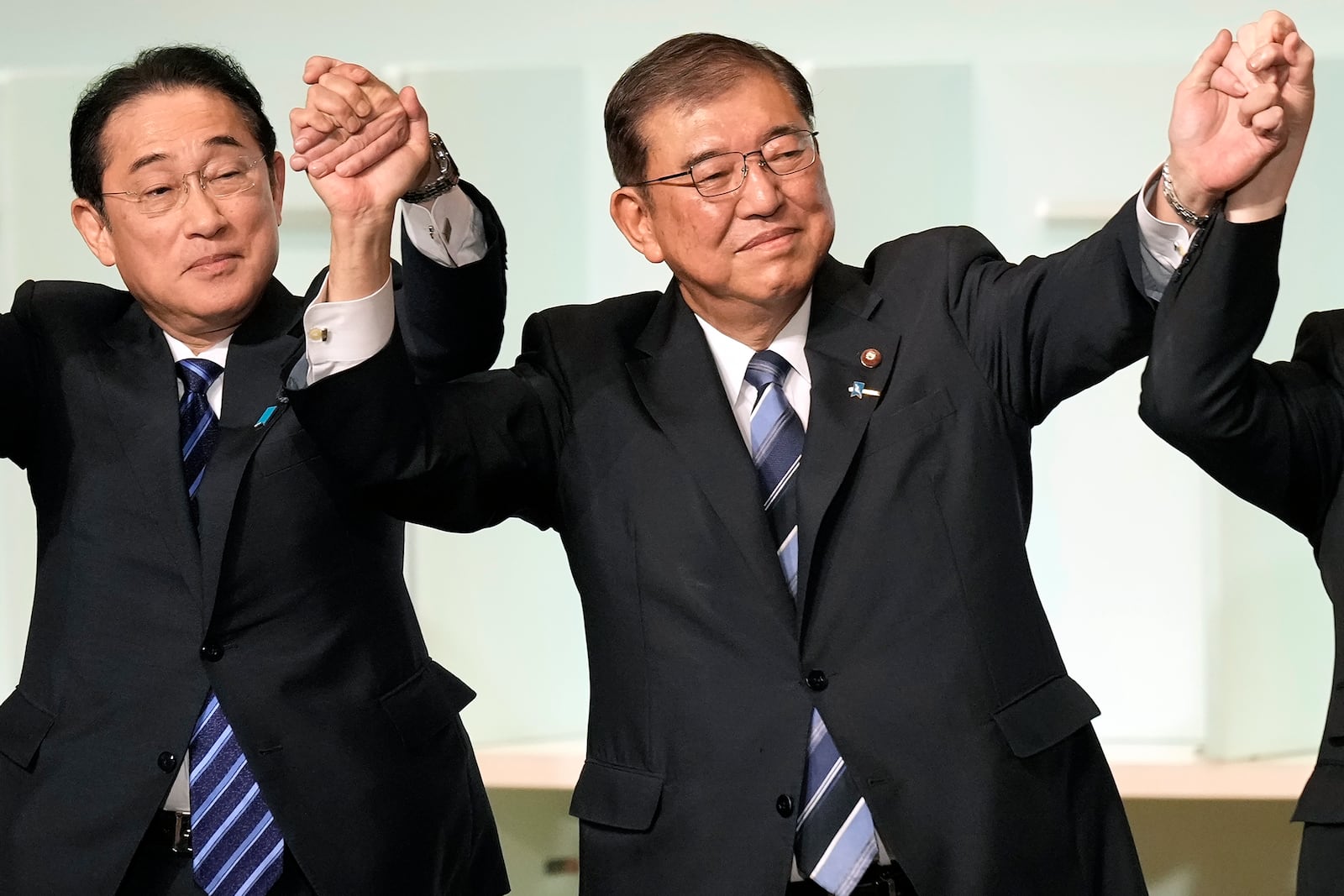 Shigeru Ishiba, right, with Japan's Prime Minister Fumio Kishida, left, and other candidates, celebrates after Ishiba was elected as new head of Japan's ruling Liberal Democratic Party during its leadership election Friday, Sept. 27, 2024, in Tokyo. (AP Photo/Hiro Komae, Pool)