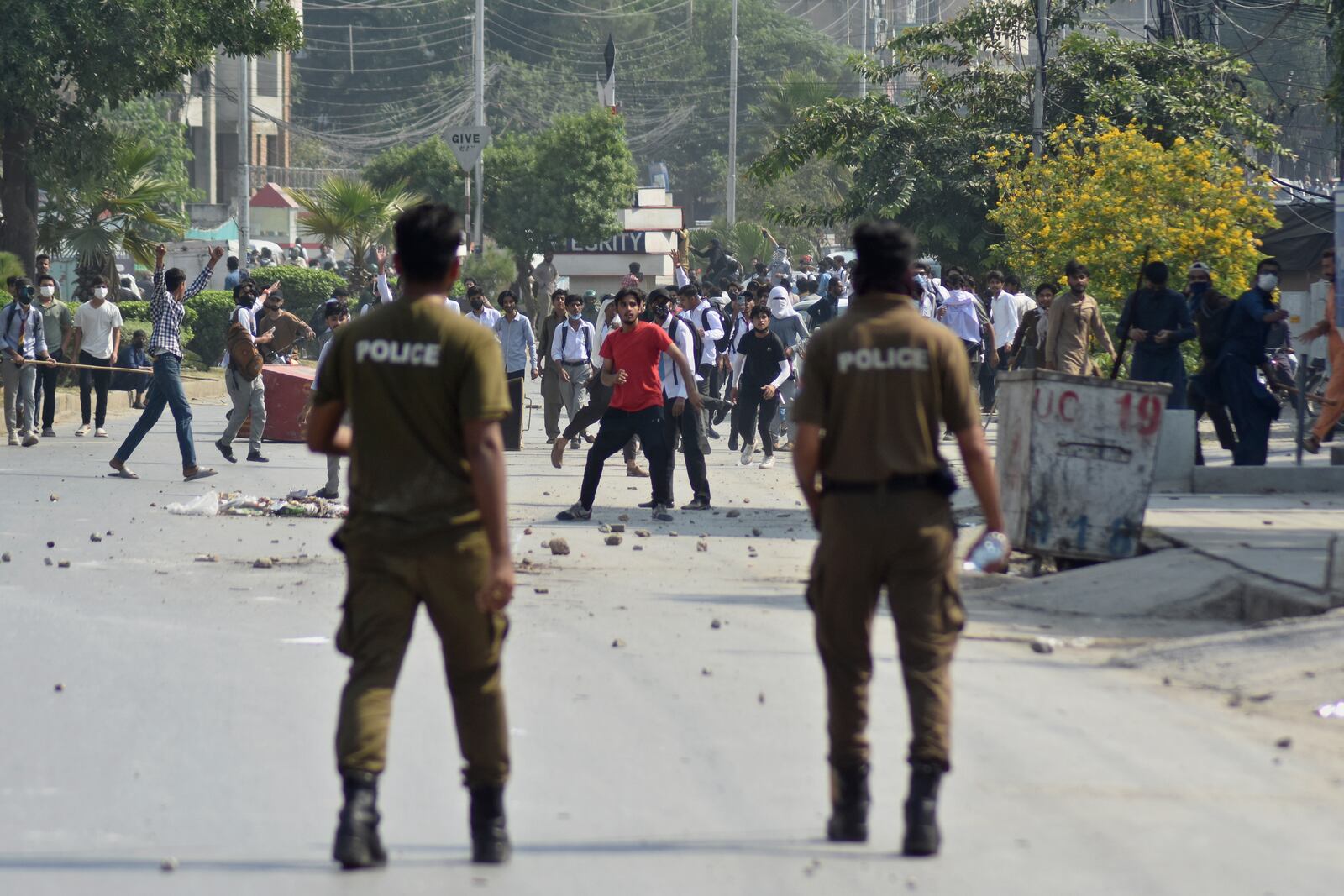 Students throw stones toward police during clashes as they protest over an alleged on-campus rape in Punjab, in Rawalpindi, Pakistan, Thursday, Oct. 17, 2024. (AP Photo/W.K. Yousafzai)