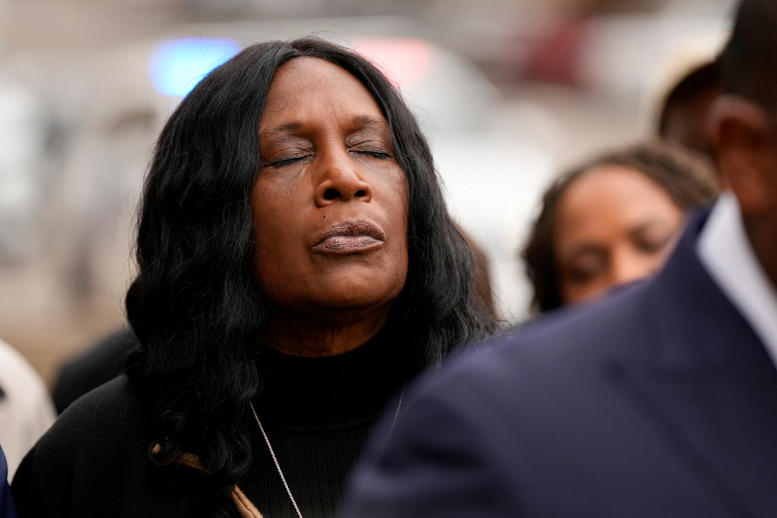 RowVaughn Wells, mother of Tyre Nichols, closes her eyes during a prayer vigil outside the federal courthouse during the trial of three former Memphis police officers accused of killing her son Wednesday, Sept. 25, 2024, in Memphis, Tenn. (AP Photo/George Walker IV)