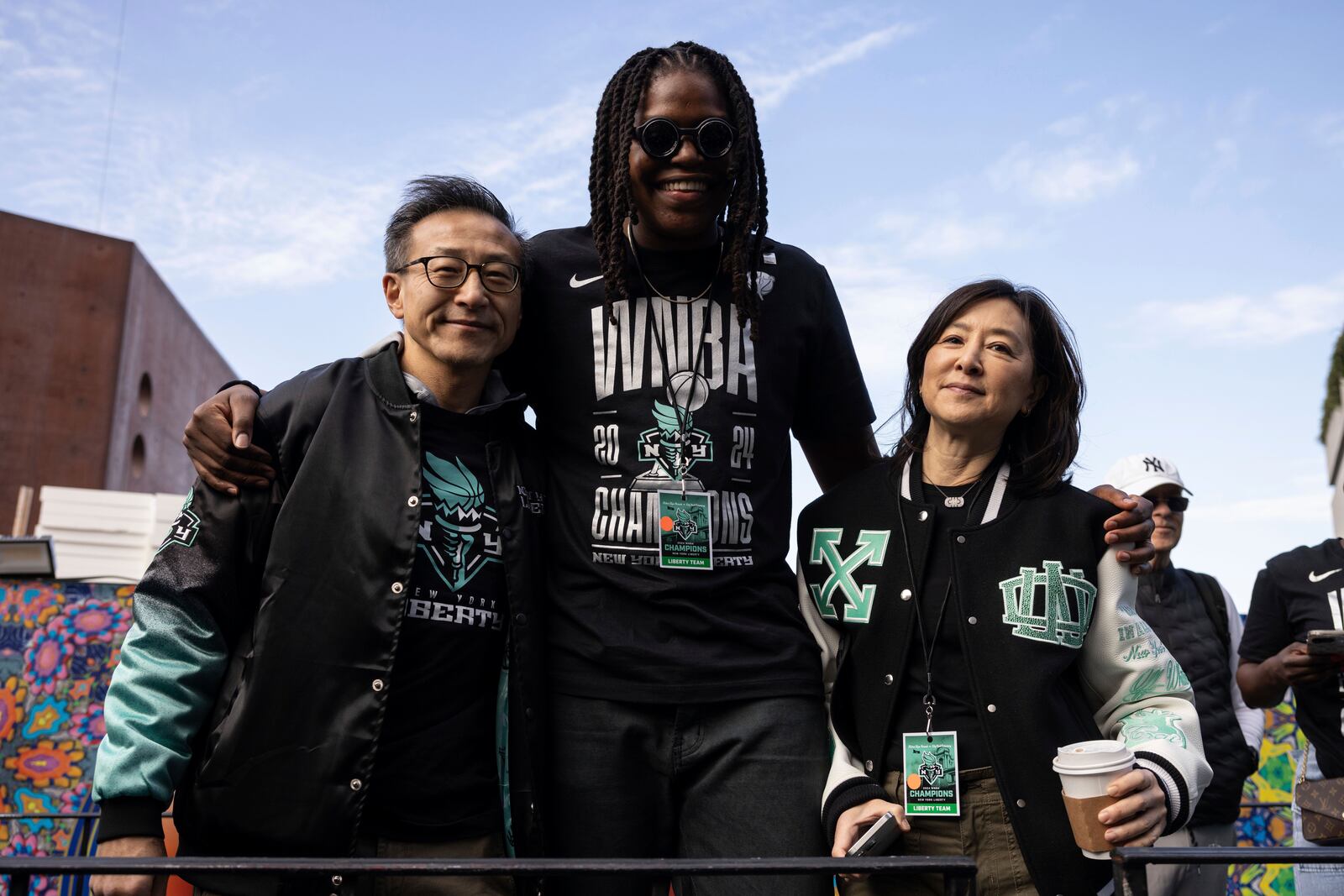 New York Liberty's owner Joe Tsai, left, and Clara Wu Tsai, right, pose with New York Liberty's center Jonquel Jones before the WNBA championship team's parade Thursday, Oct. 24, 2024, in New York. (AP Photo/Yuki Iwamura)