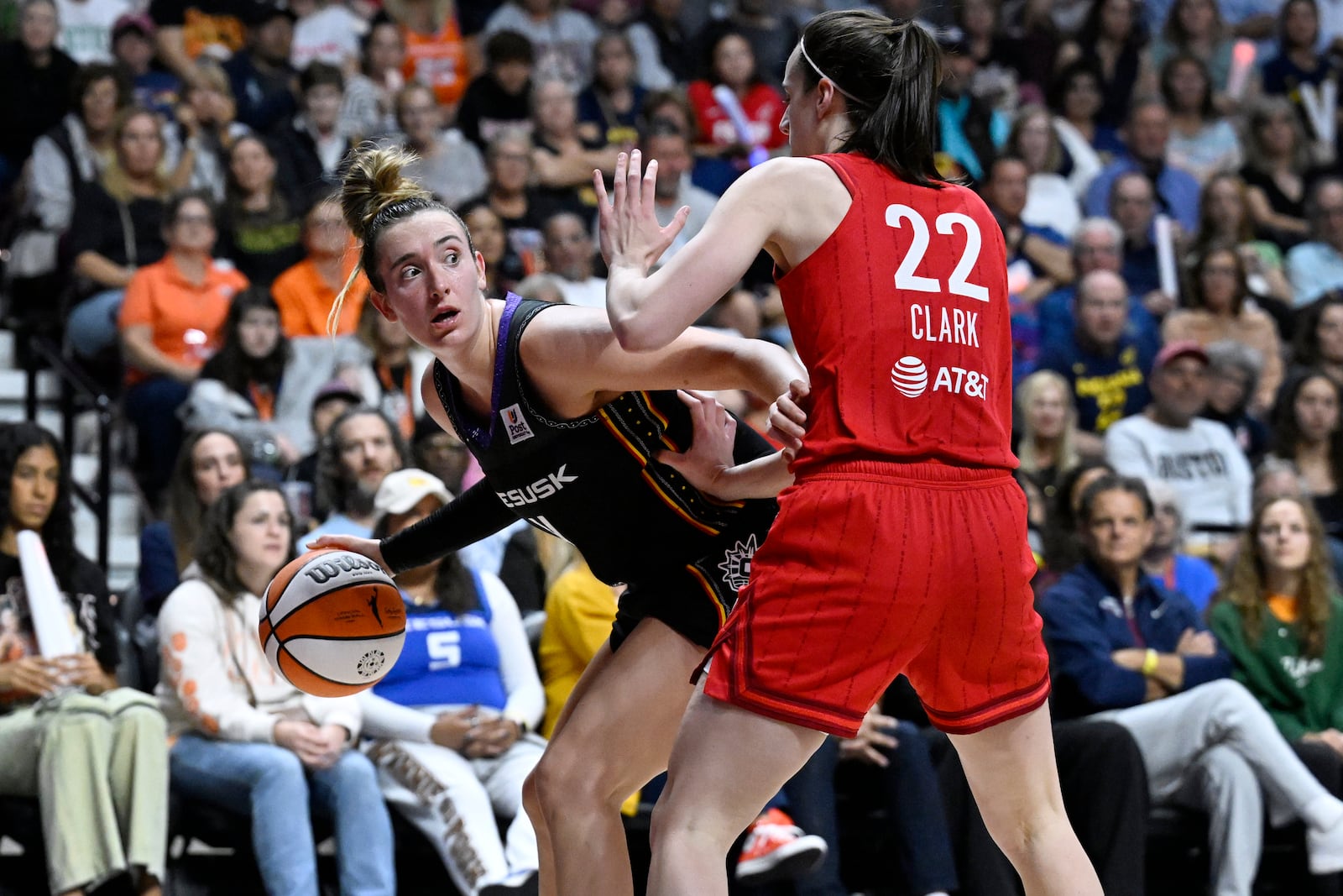 Connecticut Sun guard Marina Mabrey, left, is guarded by Indiana Fever guard Caitlin Clark during the second half of a first-round WNBA basketball playoff game, Wednesday, Sept. 25, 2024, in Uncasville, Conn. (AP Photo/Jessica Hill)