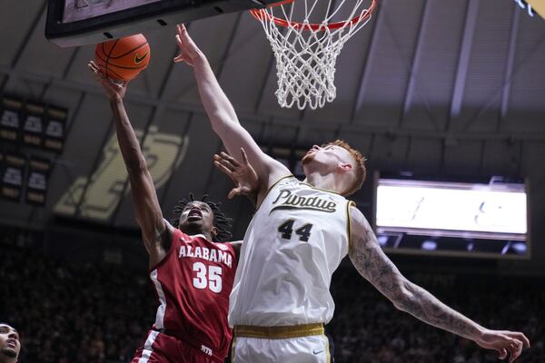 Purdue center Will Berg (44) blocks the shot over Alabama forward Derrion Reid (35) during the first half of an NCAA college basketball game in West Lafayette, Ind., Friday, Nov. 15, 2024. (AP Photo/Michael Conroy)