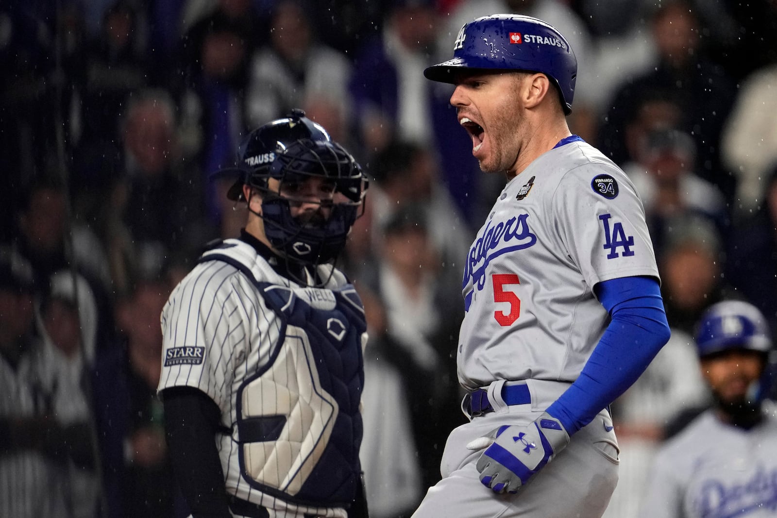 Los Angeles Dodgers' Freddie Freeman (5) celebrates after hitting a two-run home run as New York Yankees catcher Austin Wells watches during the first inning in Game 4 of the baseball World Series, Tuesday, Oct. 29, 2024, in New York. (AP Photo/Godofredo A. Vásquez)