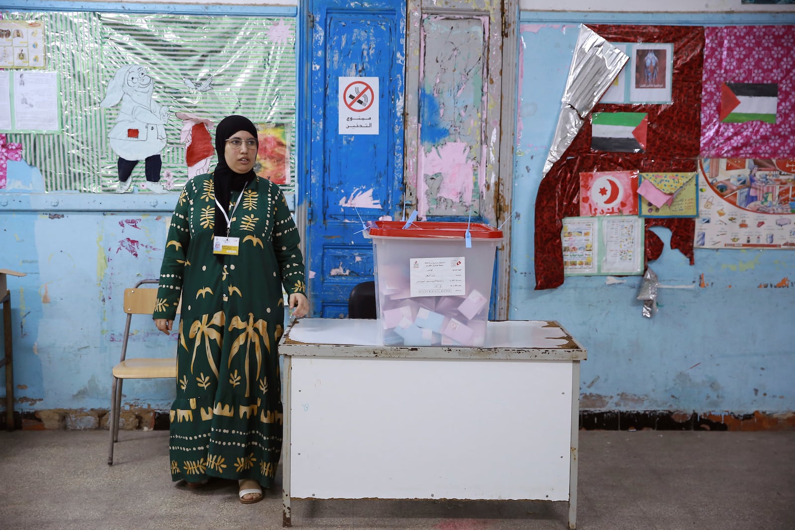 An election official stands next to a ballot box ahead of the vote counting after the presidential elections in the capital Tunis, Tunisia, Sunday, Oct. 6, 2024. (AP Photo/Anis Mili)