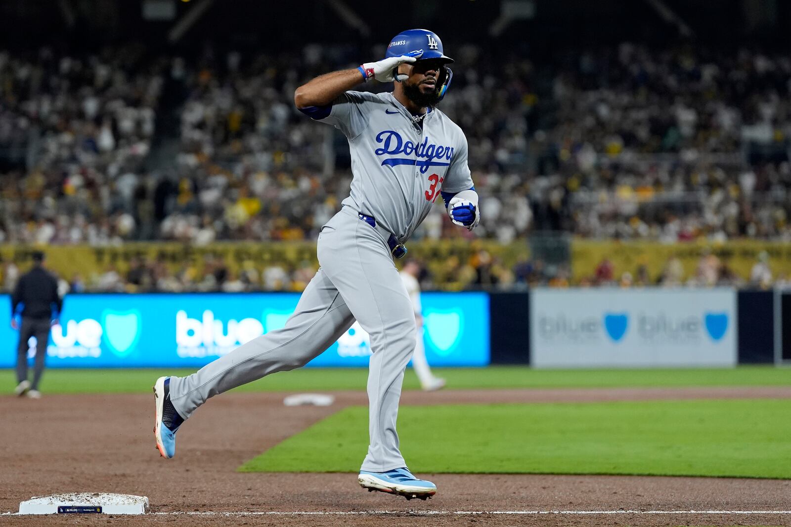 Los Angeles Dodgers' Teoscar Hernández reacts as he rounds third base after his grand slam during the third inning in Game 3 of a baseball NL Division Series against the San Diego Padres, Tuesday, Oct. 8, 2024, in San Diego. (AP Photo/Gregory Bull)