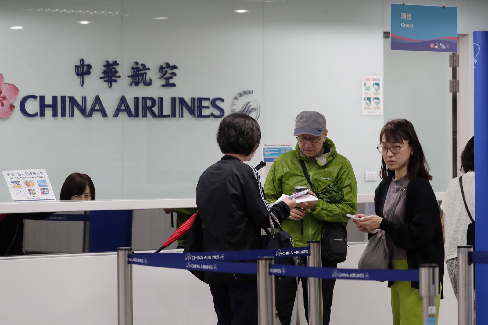 People went to airline counters at an airport to ask about canceled flights due to approaching Typhoon Krathon, in Kaohsiung, southern Taiwan, Wednesday, Oct. 2, 2024. (AP Photo/Chiang Ying-ying)