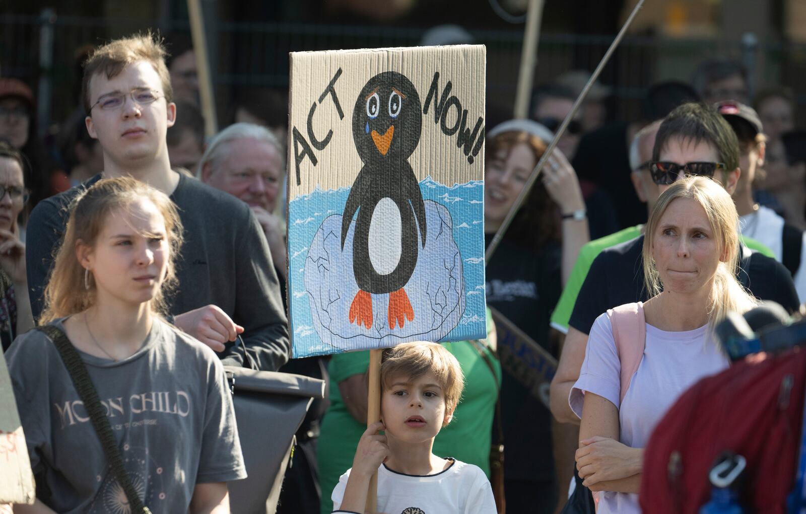 A kid holds a placard during a Fridays for Future protest in Frankfurt, Germany, Friday Sept. 20, 2024. (Boris Roessler/dpa via AP)