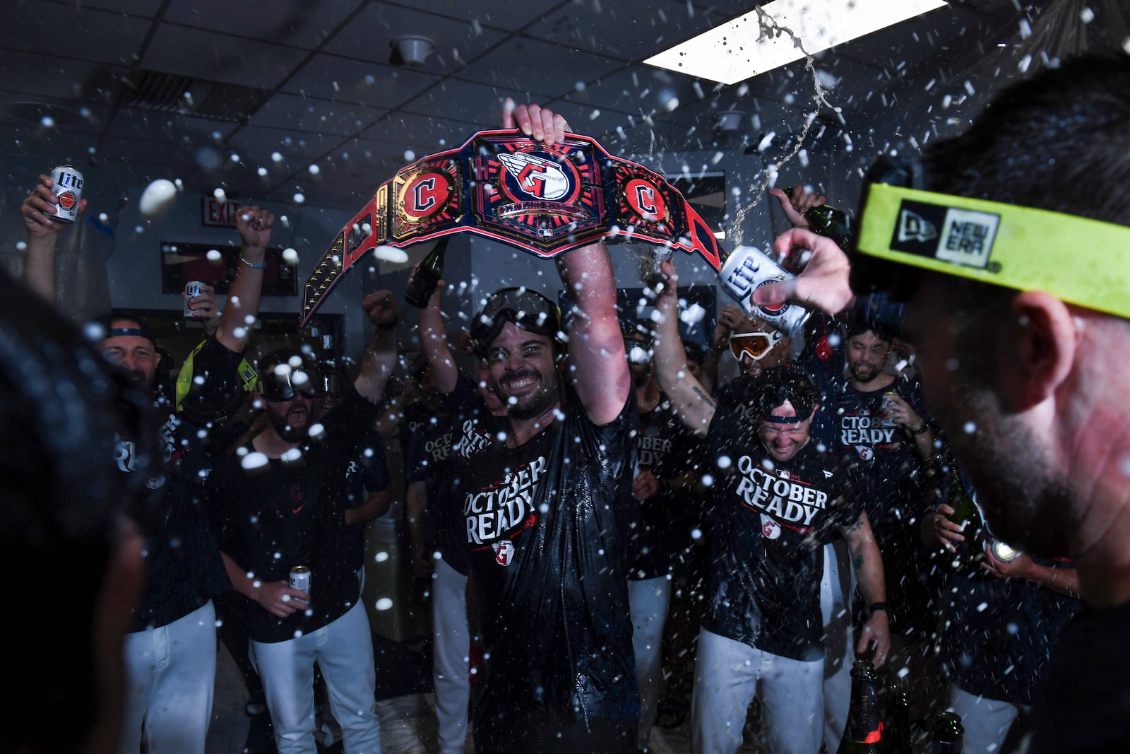 The Cleveland Guardians celebrate in the clubhouse after they defeated the Minnesota Twins to clinch a baseball playoff berth, Thursday, Sept. 19, 2024, in Cleveland. (AP Photo/Nick Cammett)