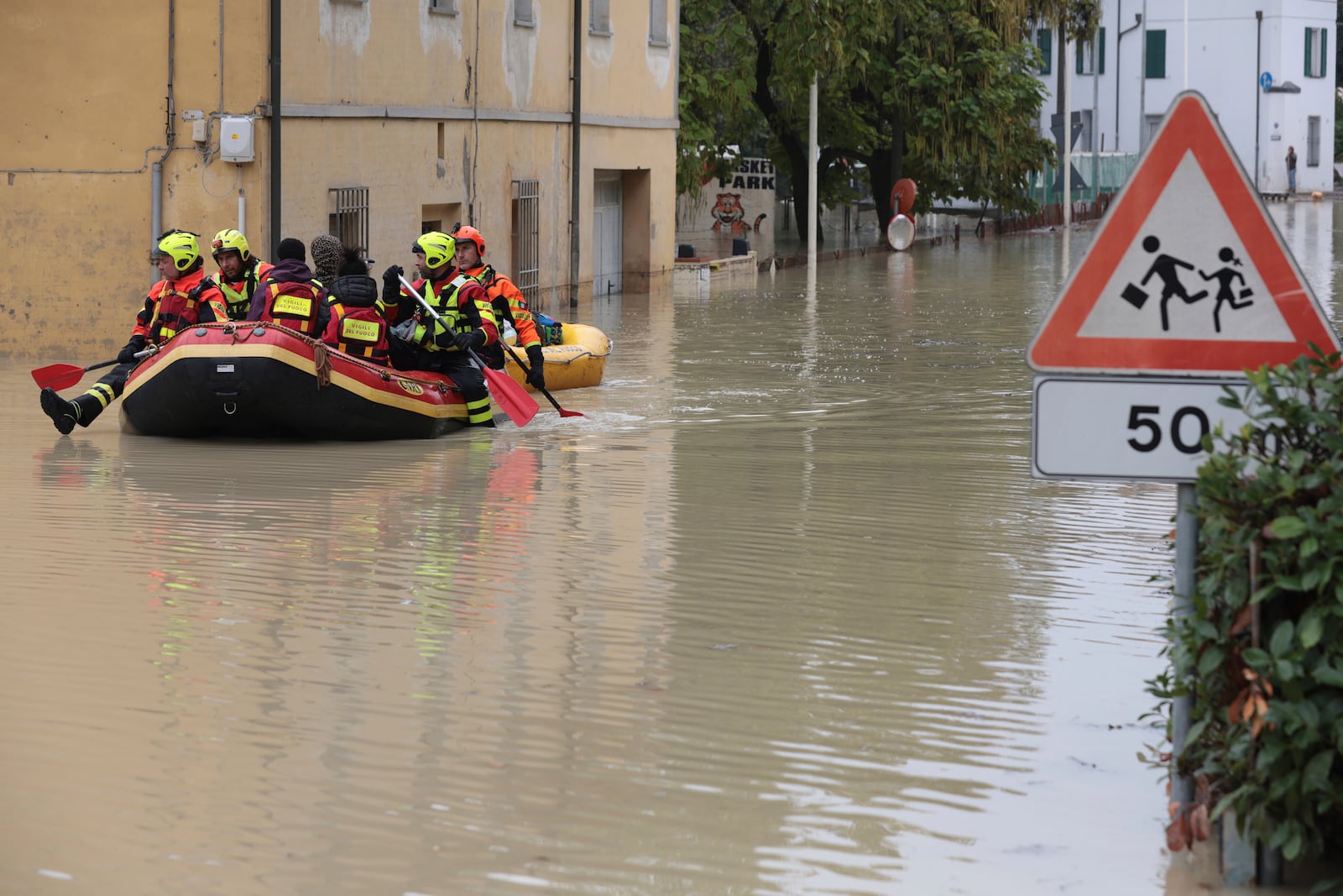 Firefighters use a dingy boat to evacuate civilians after flooding in Faenza, in the region of Emilia Romagna, Italy, Thursday, Sept. 19, 2024. (Fabrizio Zani/LaPresse via AP)