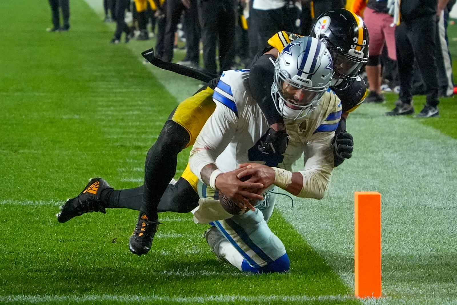 Dallas Cowboys quarterback Dak Prescott, front, is stopped short of the goal line by Pittsburgh Steelers safety Minkah Fitzpatrick during the second half of an NFL football game, early Monday, Oct. 7, 2024, in Pittsburgh. The Cowboys won 20-17. (AP Photo/Gene J. Puskar)