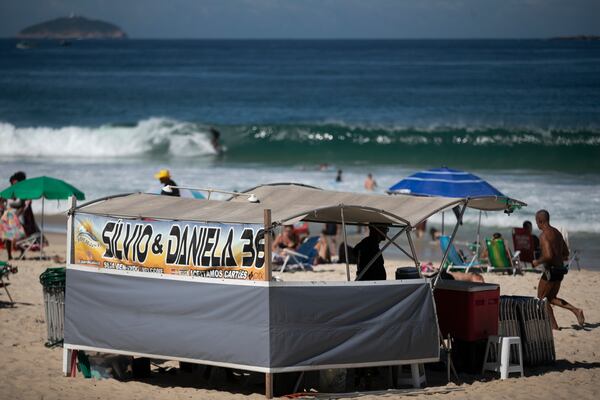 A food vendor operates a stand that also rents chairs and umbrellas on Ipanema Beach in Rio de Janeiro, Sunday, May 25, 2025. (AP Photo/Bruna Prado)