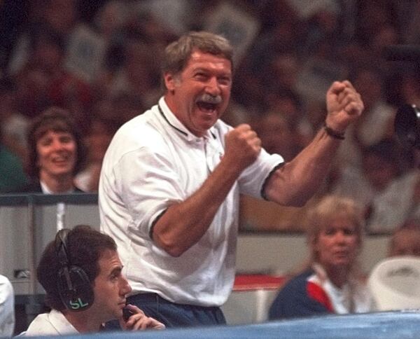 FILE - Bela Karolyi reacts with joy as his gymnastics student Kerri Strug finishes a nice routine on the balance beam during the optional portion of the U.S. Olympic Trials in gymnastics, June 30, 1996, in Boston. (AP Photo/Elise Amendola, File)