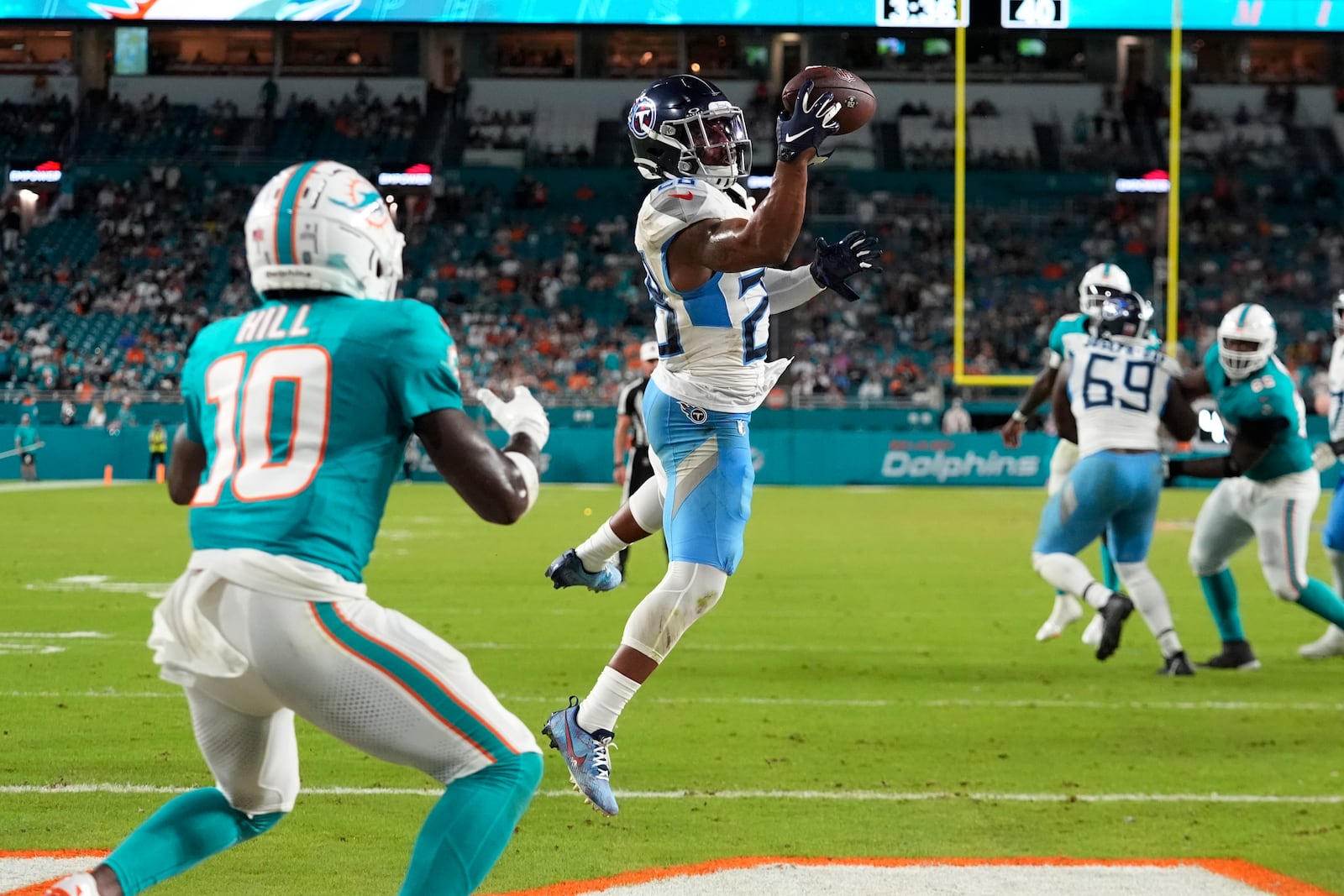 Tennessee Titans safety Quandre Diggs (28) intercepts a pass in the endzone intended for Miami Dolphins wide receiver Tyreek Hill (10) during the second half of an NFL football game, Monday, Sept. 30, 2024, in Miami Gardens, Fla. (AP Photo/Rebecca Blackwell)