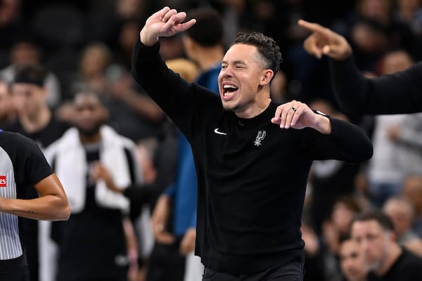 San Antonio Spurs acting head coach Mitch Johnson yells to his players during the first half of an Emirates NBA Cup basketball game against the Oklahoma City Thunder, Tuesday, Nov. 19, 2024, in San Antonio. (AP Photo/Darren Abate)