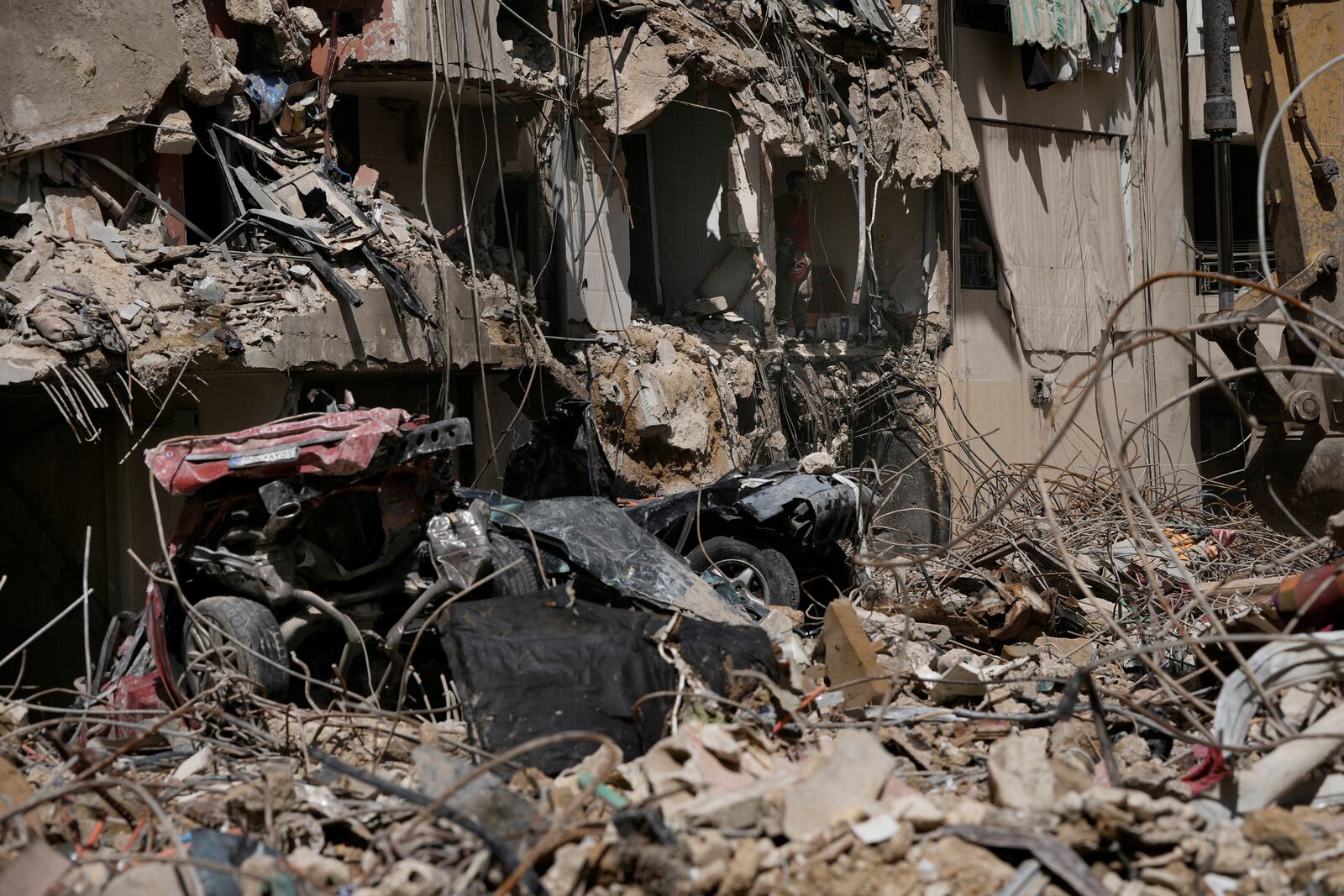 An emergency worker speaks on the phone during rescue efforts at the site of Friday's Israeli strike in Beirut's southern suburb, Sunday, Sept. 22, 2024. (AP Photo/Bilal Hussein)