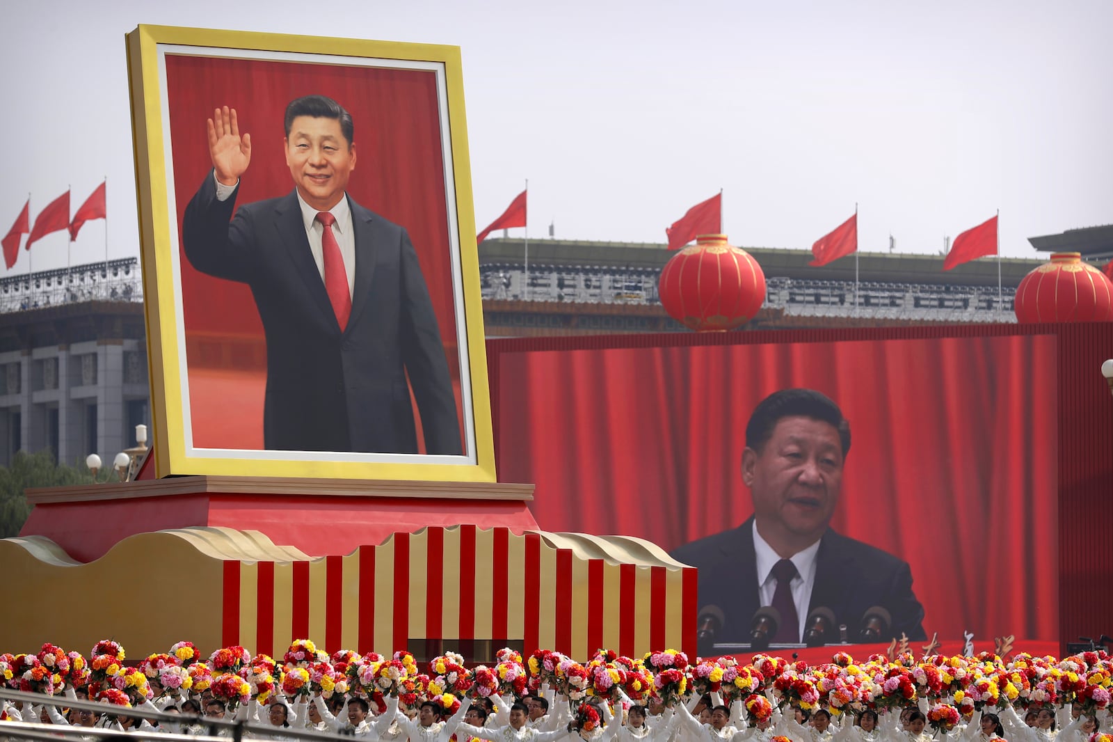 FILE - Participants cheer beneath a large portrait of Chinese President Xi Jinping during a parade to commemorate the 70th anniversary of the founding of Communist China in Beijing, Tuesday, Oct. 1, 2019. (AP Photo/Mark Schiefelbein, File)