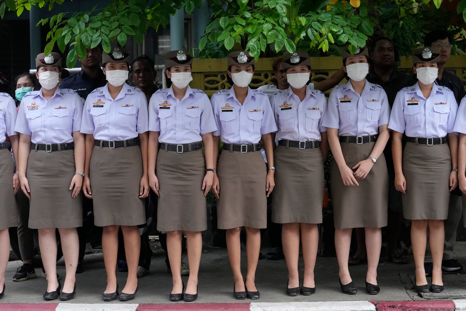 Nurse students pay respect to one of the victims of a school bus fire, at Police hospital in Bangkok, Thailand, Wednesday, Oct. 2, 2024. (AP Photo/Sakchai Lalit)