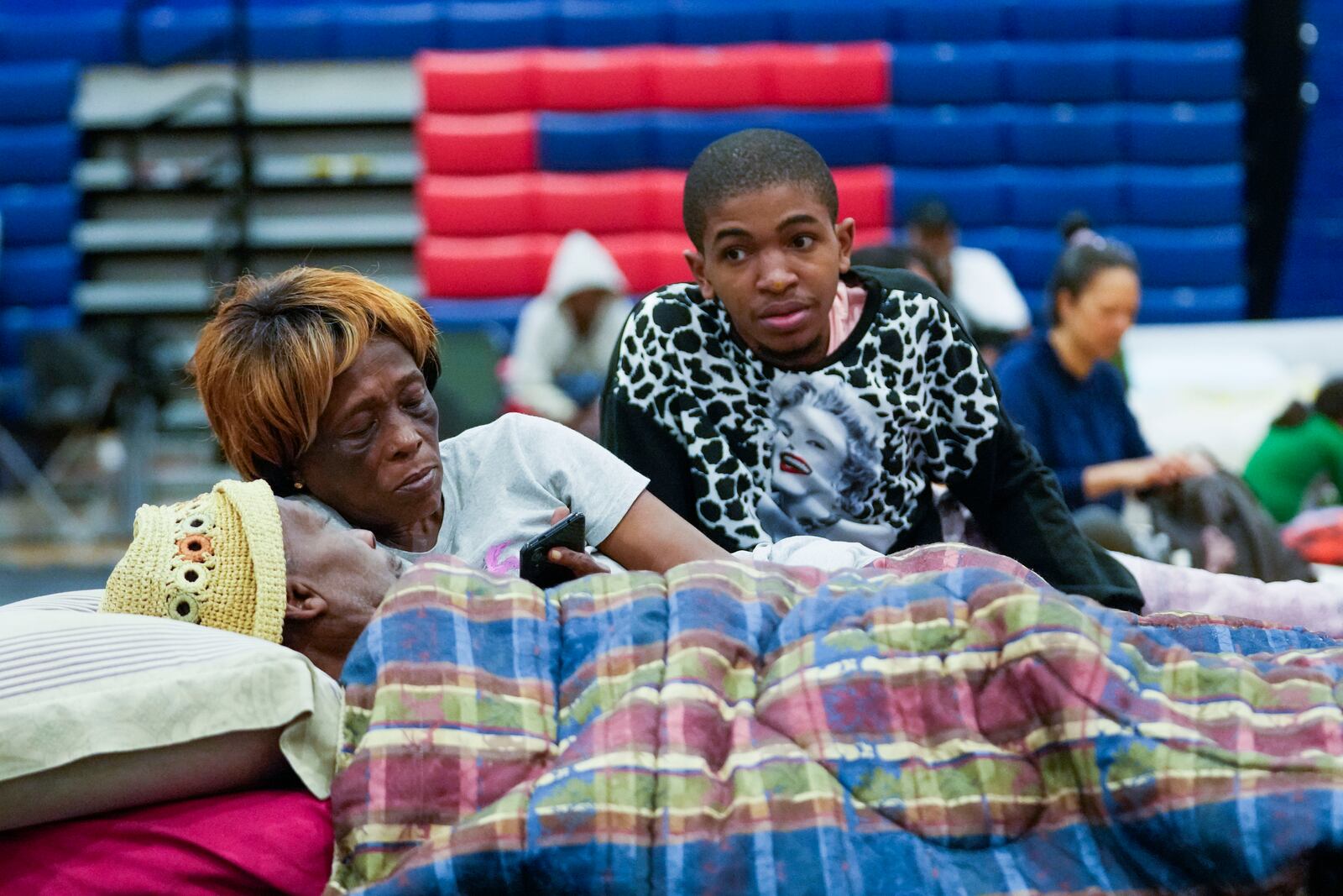 Bobby Joe Edwards, Sr., and his wife Lillie Edwards, of Walkalla, Fla., and their grandson Tavarrious Dixon, right, rest inside a hurricane evacuation shelter at Fairview Middle School, ahead of Hurricane Helene, expected to make landfall here today, in Leon County, Fla., Thursday, Sept. 26, 2024. (AP Photo/Gerald Herbert)