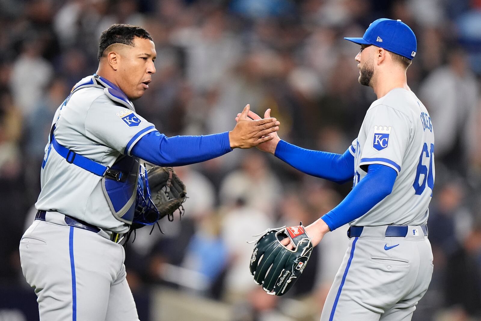 Kansas City Royals pitcher Lucas Erceg (60) and catcher Salvador Perez (13) celebrate after beating the New York Yankees in Game 2 of the American League baseball playoff series, Monday, Oct. 7, 2024, in New York. (AP Photo/Frank Franklin II)