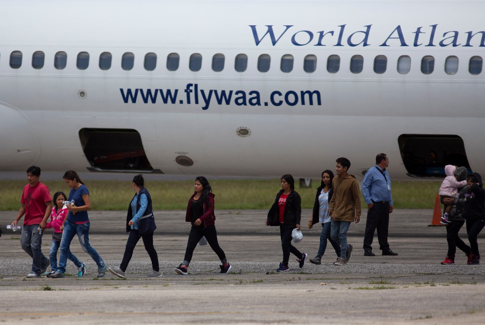 FILE - In this Aug. 20, 2019, file photo, Guatemalans who were deported from the United States arrive to La Aurora International airport in Guatemala City. (AP Photo/Moises Castillo, File)