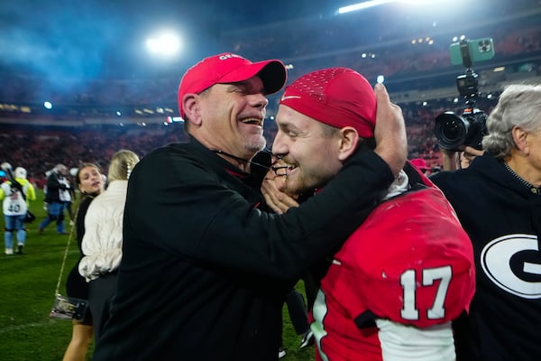 Georgia offensive coordinator Mike Bob and defensive back Dan Jackson (17) celebrate defeating Tennessee in an NCAA college football game, Saturday, Nov. 16, 2024, in Athens, Ga. (AP Photo/John Bazemore)