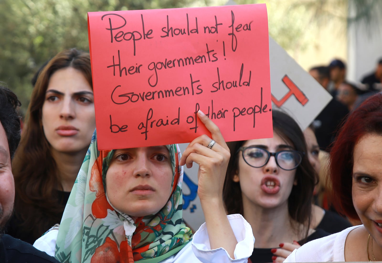 Members of the opposition and civil society groups shout slogans and wave placards during a demonstration against Tunisia president Kais Saied, ahead of the upcoming presidential elections, in Tunis, Friday, Sept. 27, 2024. (AP Photo/Anis Mili)