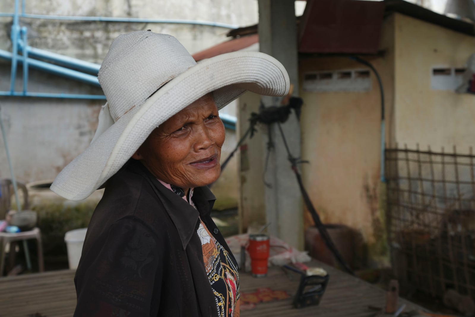 Sok Koeun, a villager who lives along the Funan Techo Canal, is interviewed by The Associated Press at her home at Prek Takeo village, eastern Phnom Penh Cambodia, Tuesday, July 30, 2024. (AP Photo/Heng Sinith)