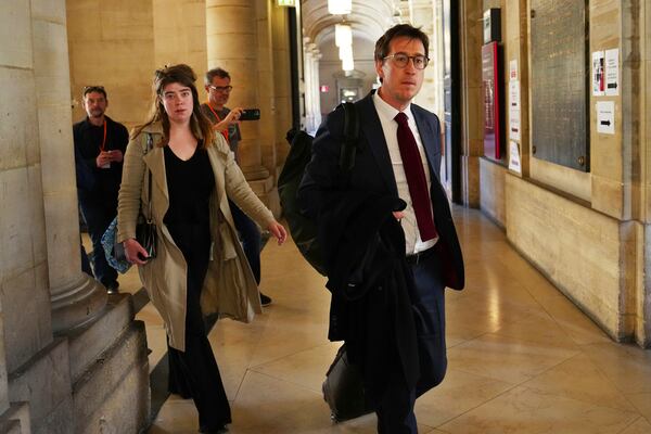 Gabriel Dumenil, right, lawyer of Yunice Abbas, one of the men accused in the 2016 armed robbery of Kim Kardashian, arrives at the palace of justice Monday, April 28, 2025 in Paris. (AP Photo/Aurelien Morissard)