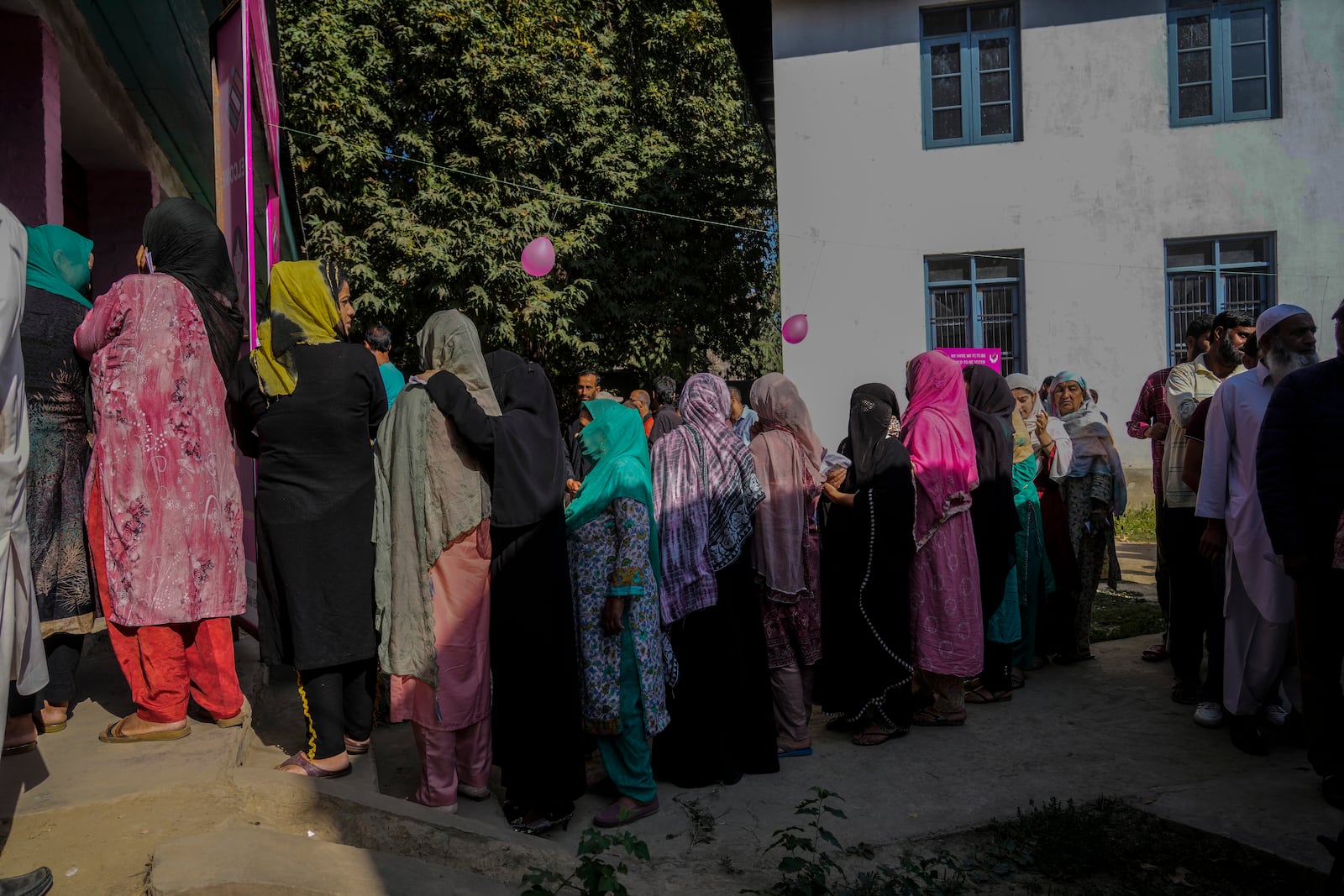 Kashmiris queue up at a polling booth to cast their vote during the final phase of an election to choose a local government in Indian-controlled Kashmir, north of Srinagar, Tuesday, Oct.1, 2024. (AP Photo/Mukhtar Khan)