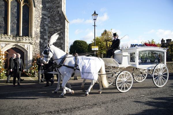 A horse-drawn carriage carrying the coffin of Liam Payne arrives for the funeral service of the One Direction singer at St Mary's Church in Amersham, Buckinghamshire, England, Wednesday Nov. 20, 2024. (Andrew Matthews/PA via AP)