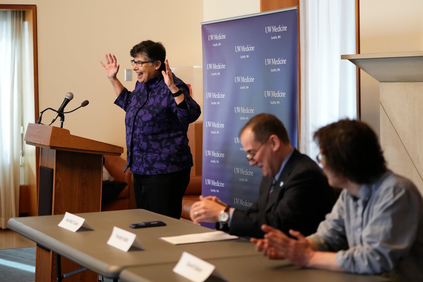 University of Washington president Ana Mari Cauce speaks as American biochemist David Baker, 2024 Nobel Prize winner in Chemistry, right, and Timothy Dellit, CEO of UW Medicine, listen during news conference at the university on Wednesday, Oct. 9, 2024, in Seattle. (AP Photo/Lindsey Wasson)